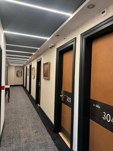 a hallway with a row of doors in a building at Brit Hotel Privil&egrave;ge Le Royal - Centre Gare in Troyes