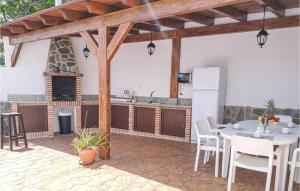 a kitchen with a table and chairs and a refrigerator at Awesome Home In Algatocín in Algatocín