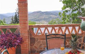 a table with a bowl of fruit on a balcony at Awesome Home In Algatocín in Algatocín