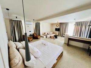 a bedroom with a bed and a living room at Gioma Garden Villas in Istron