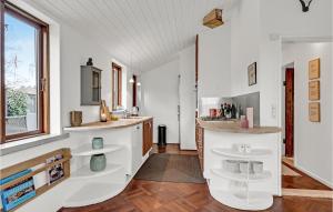 a kitchen with white cabinets and a sink at Nice Home In Ebeltoft With Wifi in Ebeltoft