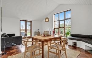 a living room with a wooden table and chairs at Nice Home In Ebeltoft With Wifi in Ebeltoft