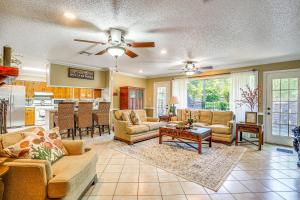 a living room with couches and a kitchen at Charming Retreat with Patio Near GramblingandRuston! in Ruston