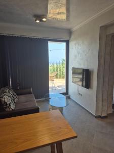 a living room with a couch and a glass table at Ivon Apartments in Sozopol