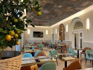 a restaurant with tables and chairs and a ceiling with fruit at Brit Hotel Privil&egrave;ge Le Royal - Centre Gare in Troyes
