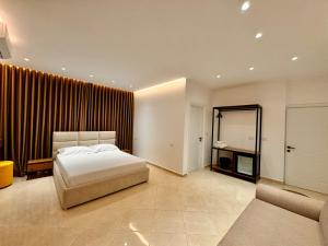a bedroom with a bed and a large window at Dine Hotel in Ksamil