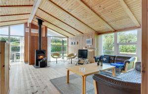 a living room with a fireplace in a house at Holiday Home Egemose Sydals I in Skovby