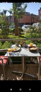een tafel met borden eten op een balkon bij Riad Qariya siyahiya in Marrakesh