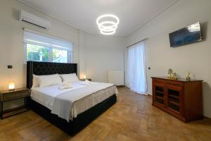 a bedroom with a bed and a dresser and a window at Villa Aegea in Kalamata +50 photos