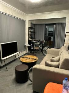 a living room with a couch and a tv at Ivon Apartments in Sozopol +9 photos