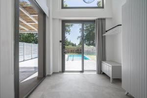 a hallway with a door leading to a pool at Astrum Luxury Suites in Vourvourou