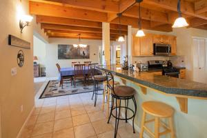 a kitchen and dining room with a counter and stools at Anderson's Alpine Retreat- Pinecrest, CA Dodge Ski in Cold Springs