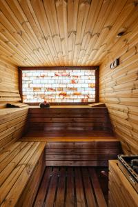 an empty wooden sauna with a window in it at Pensiunea Eden Garden Smida in Smida