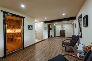 a living room with a wooden floor and a hallway at Pensiunea Eden Garden Smida in Smida