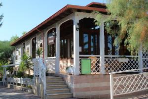 a building with a porch with a white fence at Villaggio Camping Oasi in Vieste