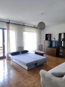 a bedroom with a large bed and a television at Apartment Luno in Zvoneće