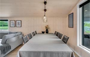 a dining room with a long table and chairs at Cozy Home In Fårvang With Wifi in Fårvang