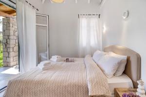 a bedroom with a bed with towels on it at Apanema Mindfulness Resort Lefkada - ultra fast Starlink WiFi in 2025 in Asprogerakata