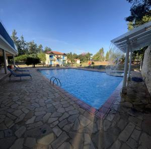 a swimming pool with a pergola next to a house at Stallage Hotel in São Pedro +14 photos