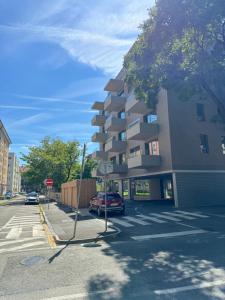 a building on a street with a stop sign and a car at Aurora Apartments in Bratislava +82 photos