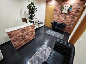 a living room with a brick wall at Room Dream Beato in Lisbon