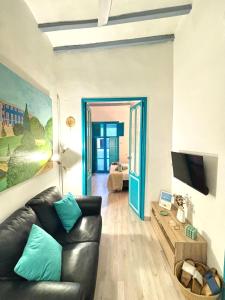 a living room with a leather couch and a television at Old Town Blue Suite in Villajoyosa