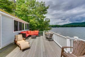 a deck with chairs and tables on a house at Massachusetts Lake House with Dock - Pets Welcome! in New Marlborough
