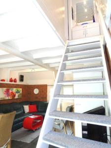 a staircase leading up to a living room with a couch at Ferienhaus Cosima mit schönem Garten in Anjum