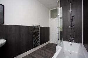 a bathroom with a shower and a tub and a sink at Vacant Nests The Attwood Smart Tv Wifi in Spennymoor +31 photos