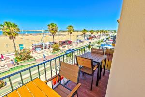 a balcony with benches and a view of a beach at Beachfront Duplex 1ª línea & Terraces Oceanfront in El Puerto de Santa María