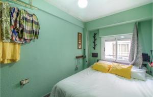 a bedroom with green walls and a bed with yellow pillows at Beautiful Apartment In Santa Pola in Santa Pola