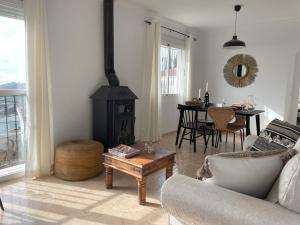 a living room with a couch and a wood stove at casita las Perlas in Cómpeta