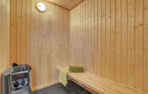 a sauna with a bench and a stove at Nice Home In Tarm With Sauna in Tarm