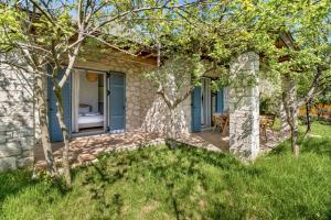 a stone house with a patio and trees at Apanema Mindfulness Resort Lefkada - ultra fast Starlink WiFi in 2025 in Asprogerakata