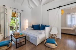 a white bedroom with a bed and a table at Apanema Mindfulness Resort Lefkada - ultra fast Starlink WiFi in 2025 in Asprogerakata