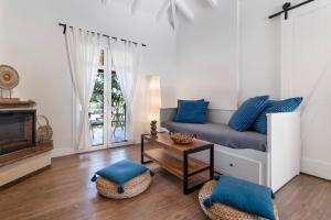 a living room with a bed and a tv at Apanema Mindfulness Resort Lefkada - ultra fast Starlink WiFi in 2025 in Asprogerakata
