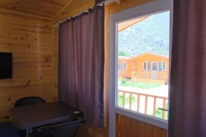 a window in a wooden room with a desk and a window at Venüs Gold Bungalov Adrasan in Kumluca