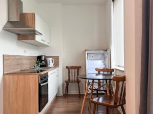 a small kitchen with a table and chairs in it at Appartements in der Kornstraße in Bremen