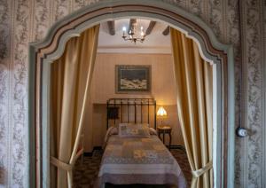 Un dormitorio con una cama y una lámpara de araña en Casa Calvo SXVI, en Santa Eulalia la Mayor