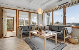 a living room with a couch and a table at 3 Bedroom Pet Friendly Home In Bogense in Bogense