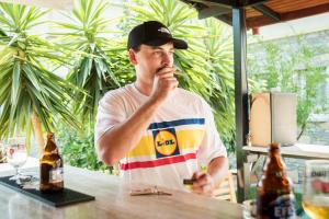 a man is sitting at a table with a bottle of beer at Ada Apart Hotel in Dalyan