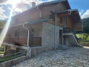 a house with a porch and a balcony at Vila Bucan in Rožaje +8 photos
