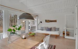 a living room with a table and a couch at Amazing Home In Rørvig With Kitchen in Rørvig