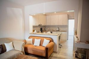 a living room with a couch and a kitchen at Betty's 4 Seasons in Agria in Agria
