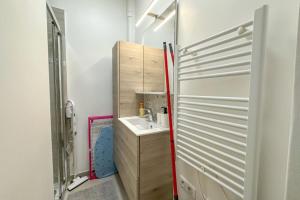 a small bathroom with a sink and a shower at Flexliving - room - Hameau in Paris