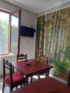 a dining room with a table and a large window at Iberia 2019 in Batumi