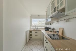 a small kitchen with a sink and a window at Flexliving - room - Losserand in Paris