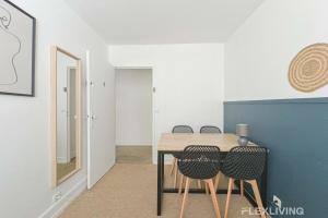 a dining room with a table and chairs at Flexliving - Room - Friant in Paris +10 photos