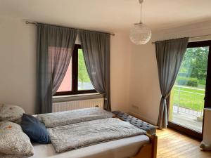 a bedroom with a bed and a large window at Ferienwohnung Familie Kirsten in Piesport