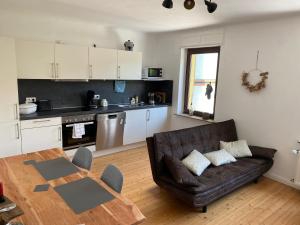 a living room with a couch and a table at Ferienwohnung Familie Kirsten in Piesport